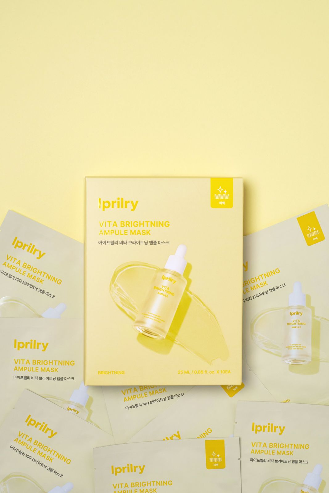 Iprilry · 아이프릴리 비타마스크 — 박스와 낱개 파우치를 함께 배치한 메인 패키지 컷, 옐로우 배경