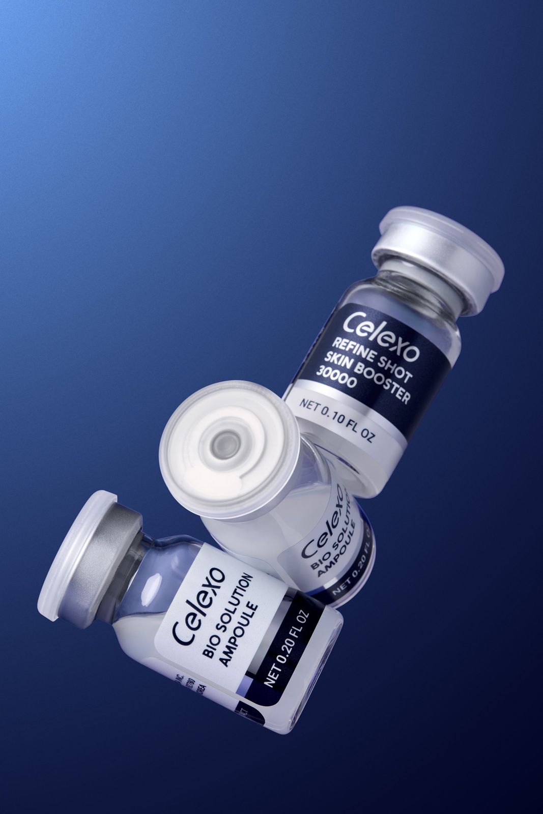 Celexo · 엑소테라피 스킨케어 — 스킨부스터 앰플과 바이오 솔루션 앰플 2병을 함께 띄운 기본 제품컷, 블루 배경