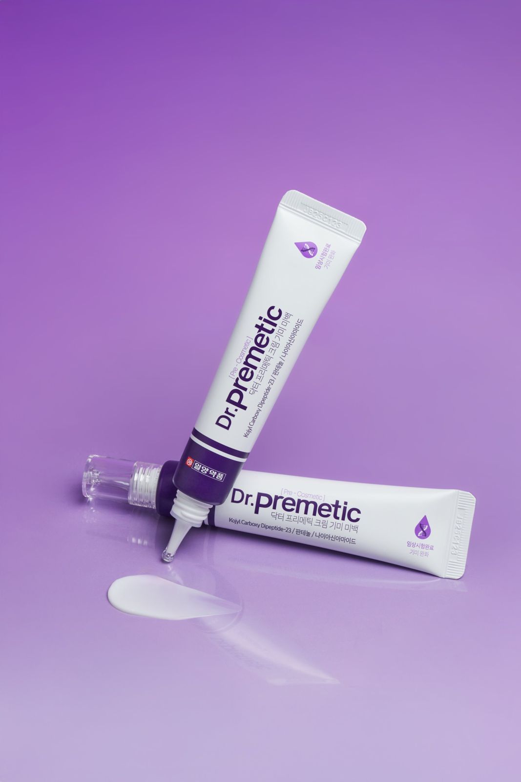Dr.PREMETIC · 미백크림 — 튜브 2개를 교차 배치한 컷, 퍼플 배경