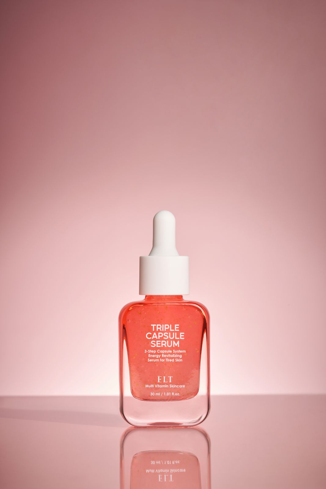 ELT COSMETIC · 캡슐세럼 — 핑크 그라데이션 배경, 반사 바닥 위 제품 단독컷