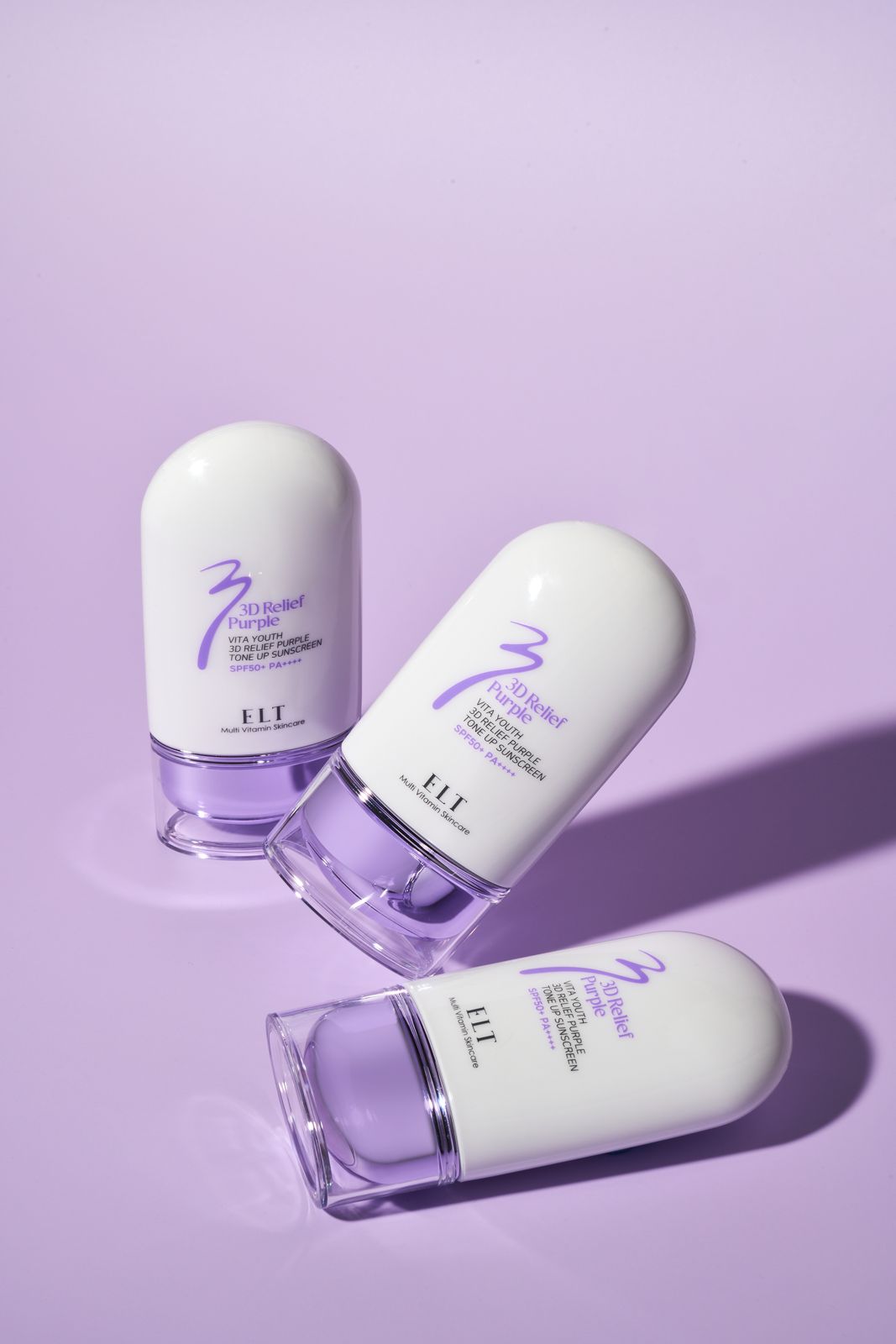 ELT COSMETIC · 선스크린 — 동일 퍼플 배경, 제품 3개를 눕혀 배치한 컷