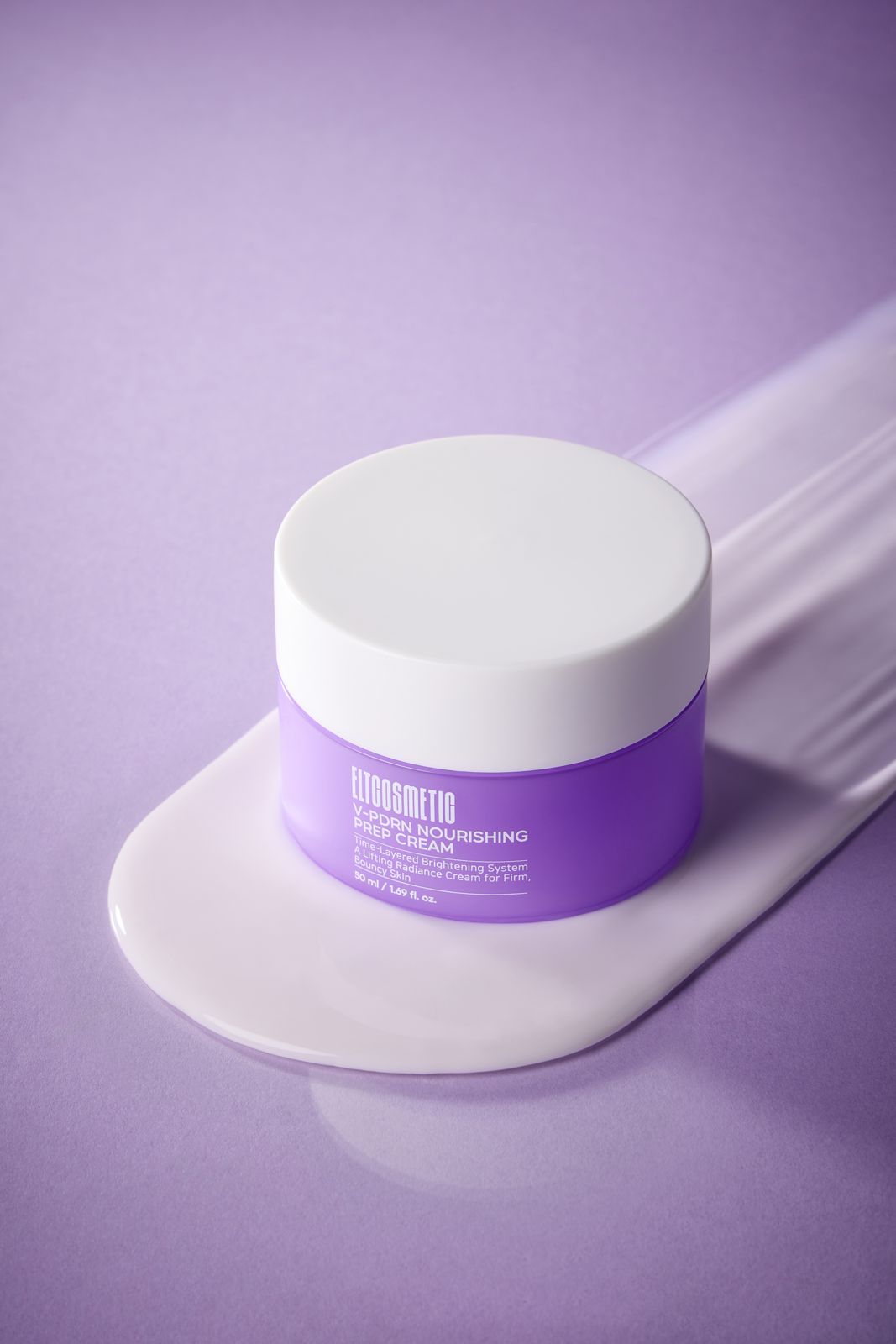 ELT COSMETIC · V-PDRN 크림 — 퍼플 배경, 제형 스와이프 위에 세운 용기 연출컷