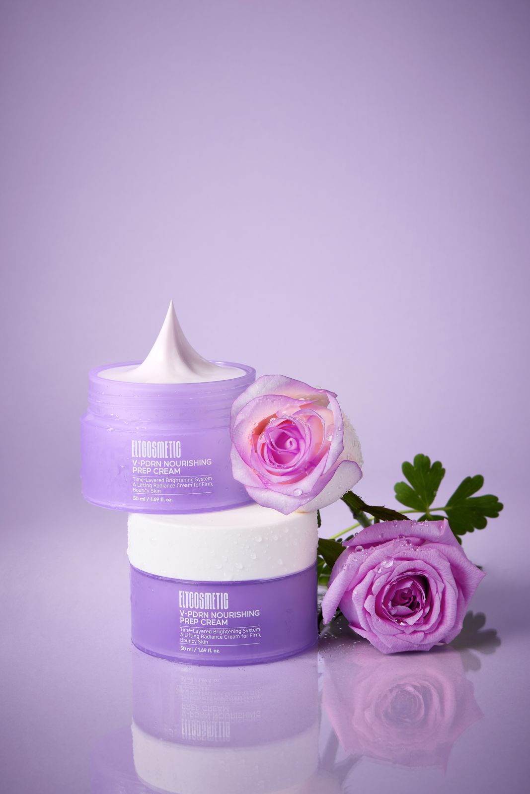 ELT COSMETIC · V-PDRN 크림 — 퍼플 배경, 용기 2개를 쌓고 물방울 맺힌 퍼플 장미와 함께 놓은 연출컷