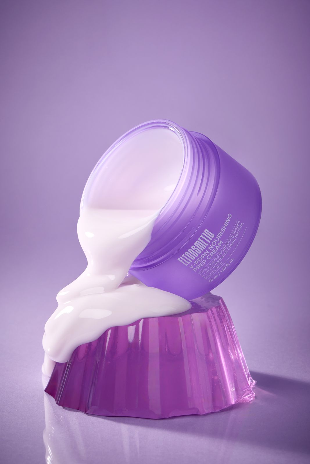 ELT COSMETIC · V-PDRN 크림 — 퍼플 배경, 푸딩위에 기울인 용기에서 제형이 흘러내리는 연출컷