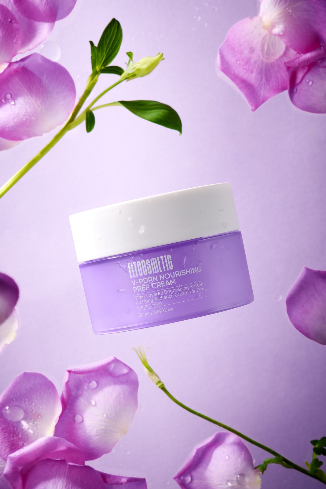 ELT COSMETIC · V-PDRN 크림 — 퍼플 배경, 장미 꽃잎과 줄기로 둘러싼 용기 연출컷