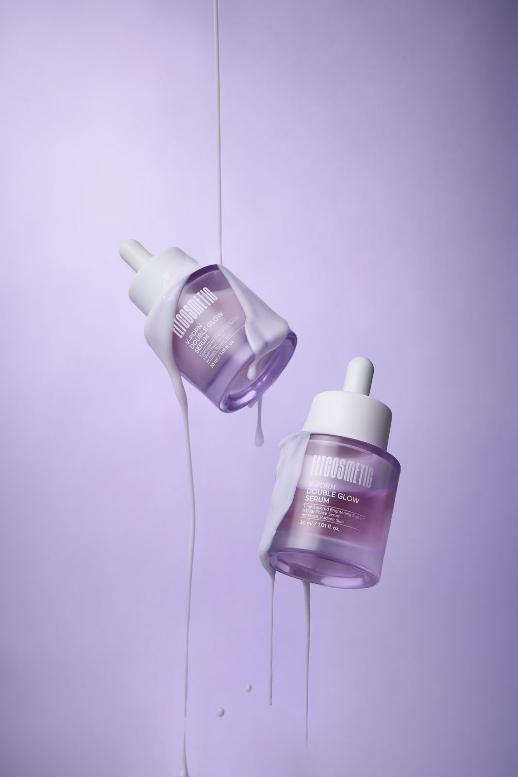 ELT COSMETIC · V-PDRN 세럼 — 병 2개가 허공에 떠 있고 제형이 흘러내리는 연출컷