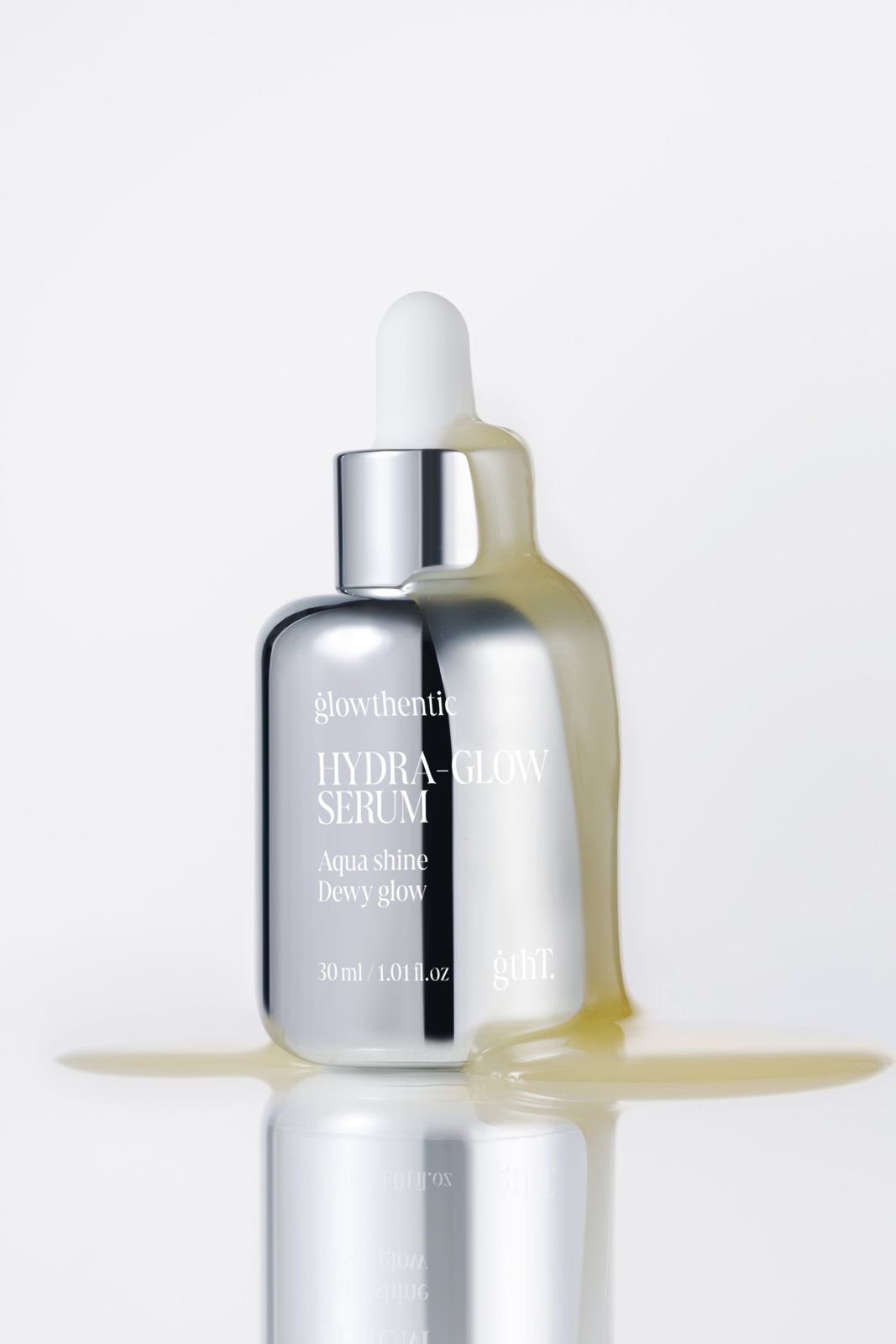 GLOWTHENTIC · 세럼 — 세럼이 흘러넘치는 텍스처 연출, 리플렉션 배경