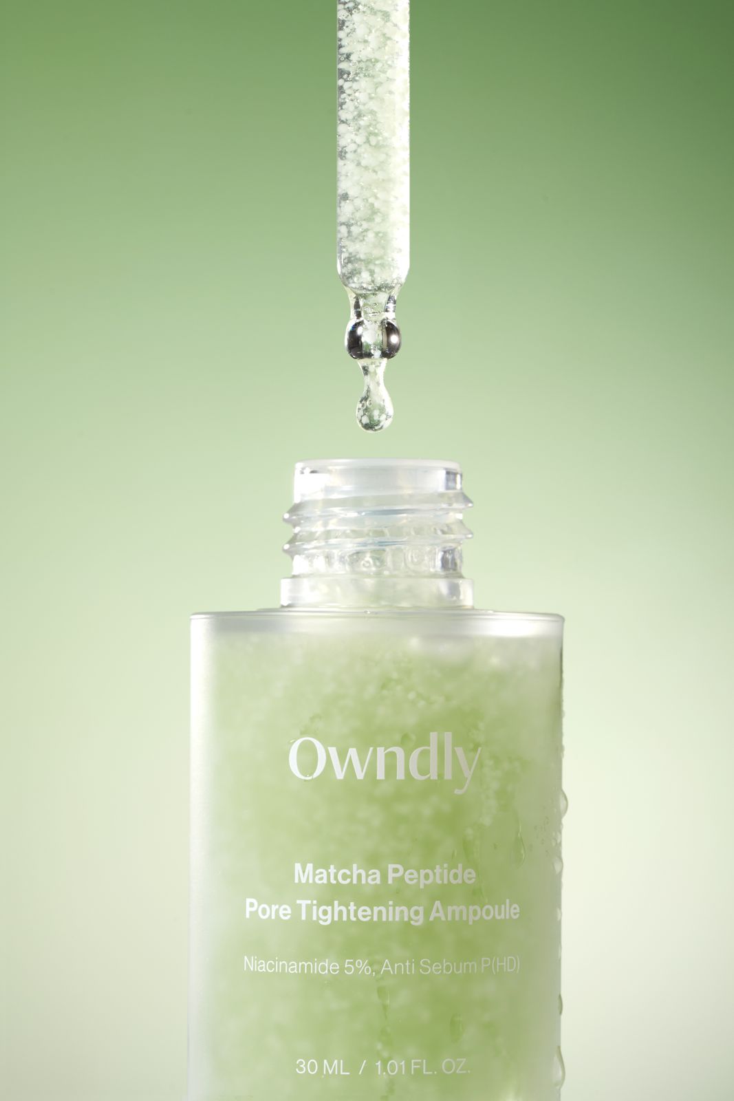 OWNDLY · 모공 타이트닝 앰플 — 열린 병 입구 위 드로퍼에서 방울이 떨어지는 클로즈업컷