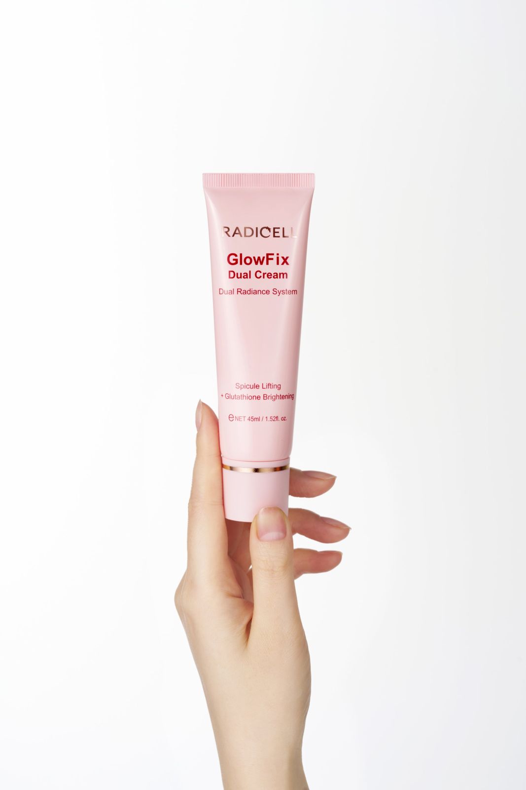 RADICELL · 글로우픽스 듀얼크림 — 손으로 제품을 세워 든 컷, 화이트 배경