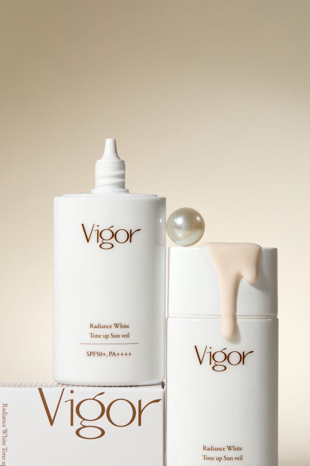 VIGOR · 선크림 — 제형 스와치와 진주 장식을 함께 배치한 연출컷