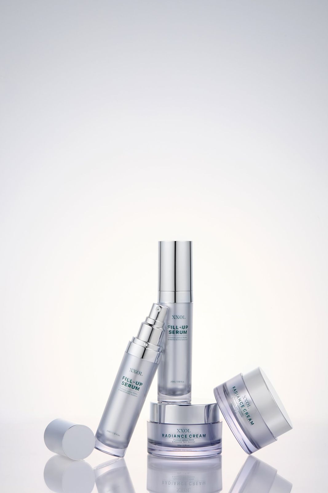 XXOL · 액솔 필업세럼 — 필업세럼과 래디언스크림을 함께 배치한 라인업 컷, 크림 뚜껑을 연 상태